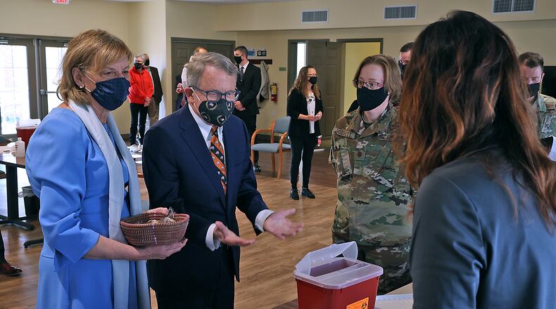 Ohio Governor Mike DeWine and his wife, Fran, talk to the nurses from the Clark County Combined Health District who were filling the COVID vaccination syringes during a visit to New Carlisle Senior Living. BILL LACKEY/STAFF