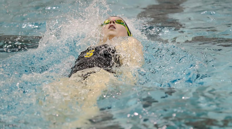 Shawnee High School sophomore Lola Derr competes in the 100 yard backstroke during the Clark County Invitational on Sunday afternoon at the Wittenberg University Natatorium in Springfield. Derr won the event in a time of 1 minute, 2.97 seconds. MICHAEL COOPER/CONTRIBUTED