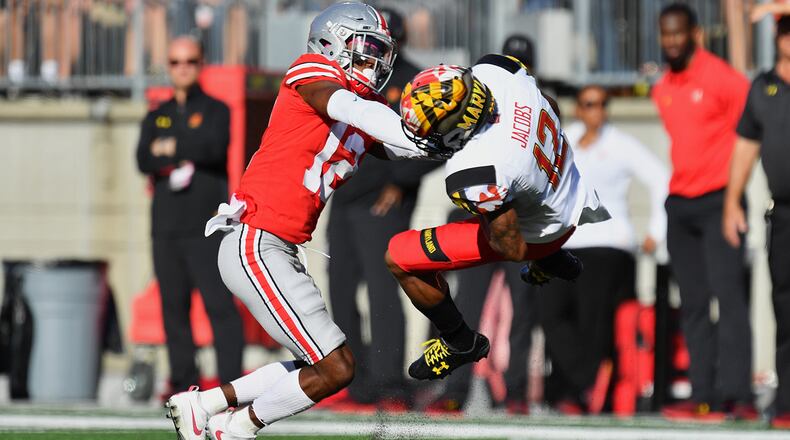 COLUMBUS, OH - OCTOBER 7: Denzel Ward #12 of the Ohio State Buckeyes hits Taivon Jacobs #12 of the Maryland Terrapins after a reception in the first quarter at Ohio Stadium on October 7, 2017 in Columbus, Ohio. Ward was ejected from the game after being assessed a targeting penalty for the hit. (Photo by Jamie Sabau/Getty Images)