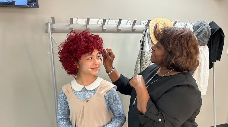 Director Monica Logan touches up Eve Choi, who plays the title character, prior to a dress rehearsal for Springfield Junior Civic Theatre's production of "Annie, Jr." that will be performed Thursday through Saturday to the John Legend Theater.