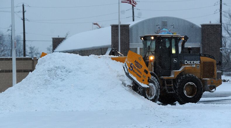 The Airway Shopping Center has large equipment, moving snow into piles in their parking lot Friday, Jan 19, 2024 to make way for customers to park. MARSHALL GORBY\STAFF