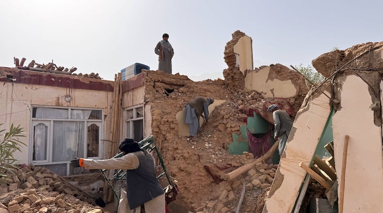 Locals search among the rubble of a destroyed house after a 6.3 powerful in a rural area of the Khulm District, Samangan Province, northern Afghanistan, Monday, Nov. 3, 2025.(AP Photo/Sirat Noori)