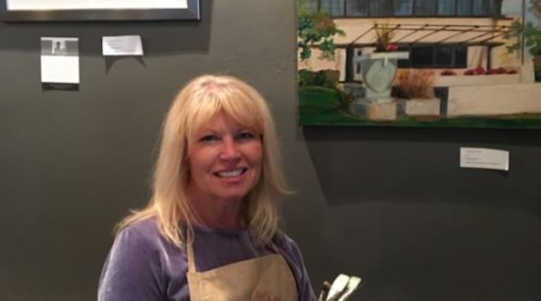 Springfield artist Robine Wright stands by her painting of the Westcott House in this file photo. Contributed photo