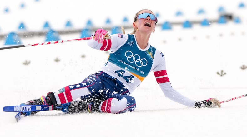 Jessie Diggins, of the United States, falls to the ground after crossing the finish line in the cross country skiing women's 10km interval start free at the 2026 Winter Olympics, in Tesero, Italy, Thursday, Feb. 12, 2026. (AP Photo/Kirsty Wigglesworth)