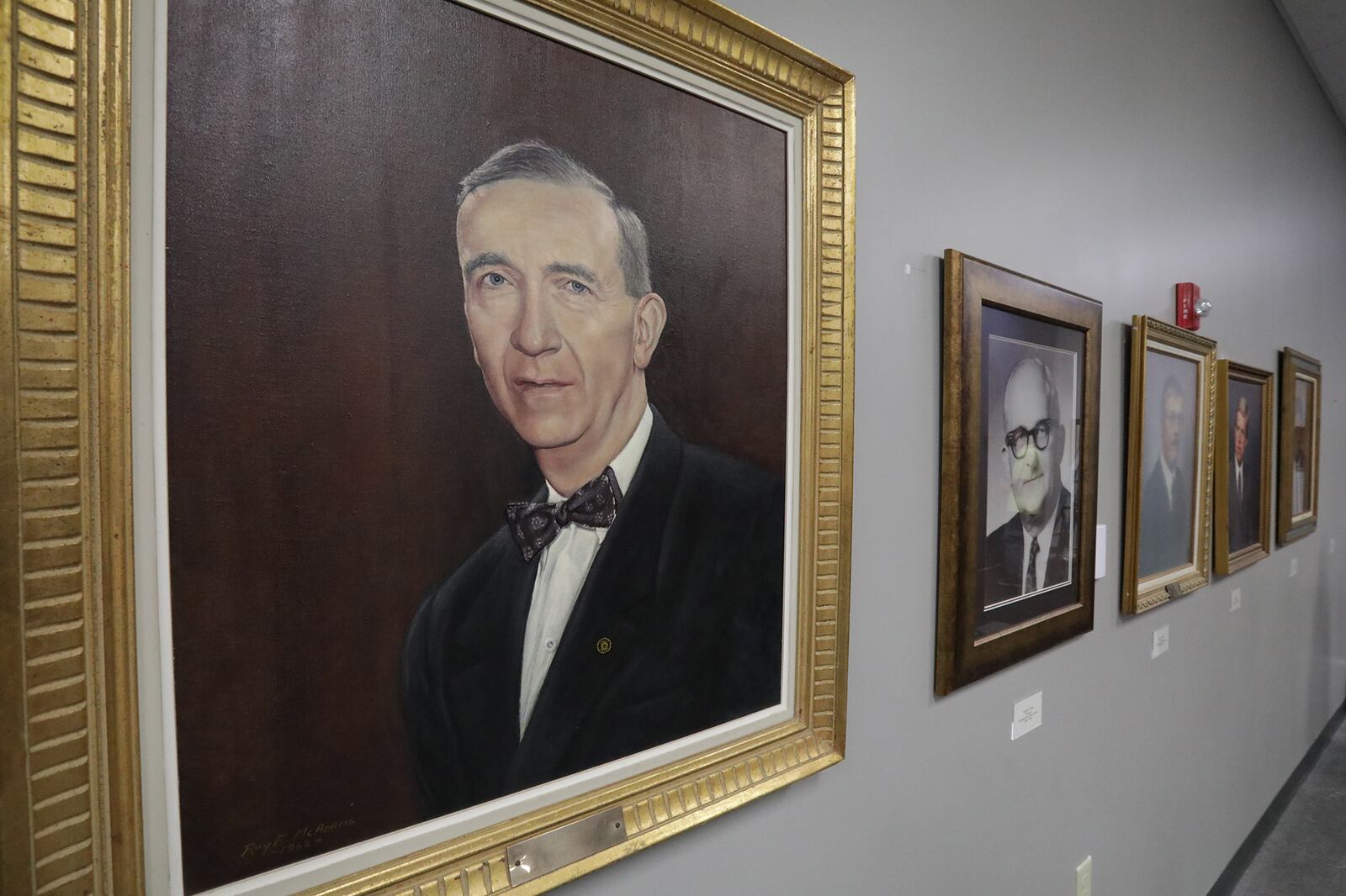 Pictures of past leaders at Springfield City Schools and historic plaques now decorate the lobby of the John Legend Theater Friday. BILL LACKEY/STAFF