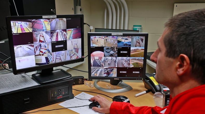Brian Dixon, director of facilities and safety at Tecumseh Schools, looks over the video feeds from the school's security cameras Thursday, Dec. 1, 2022. BILL LACKEY/STAFF