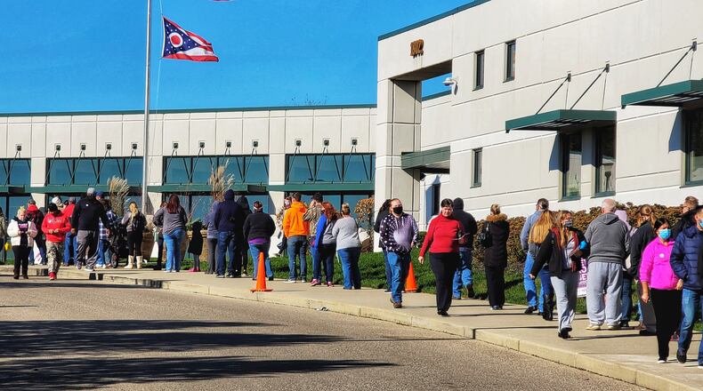 A long line forms in front of the Butler County Board of Elections on the last day of early voting Monday, Nov. 2, 2020 in Hamilton. NICK GRAHAM / STAFF