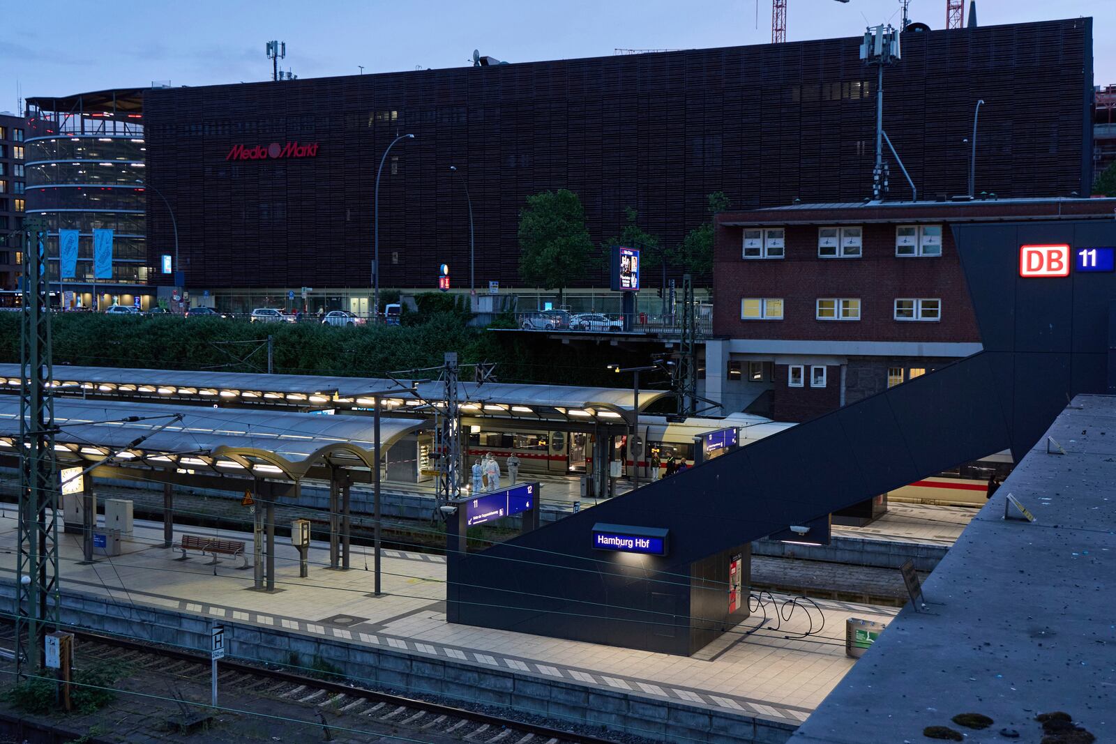 Investigators work at Hamburg, Germany's Central Station on Friday, May 23, 2025, after several people were injured in a knife attack. (Georg Wendt/dpa via AP)