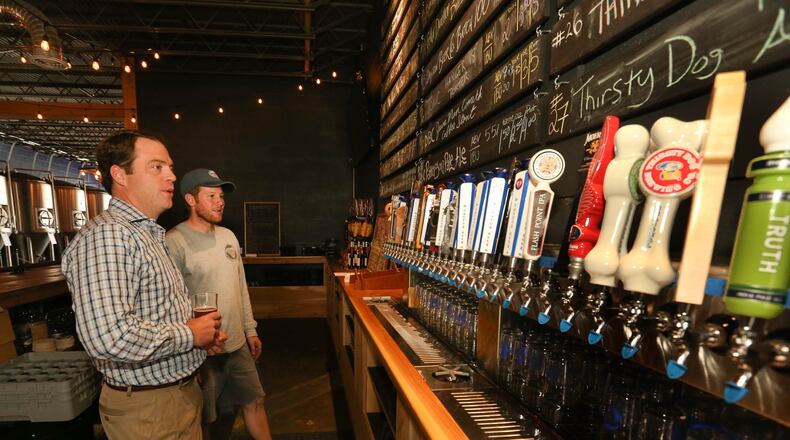 Bonbright Distributors CEO Brock Anderson, left, and Peter Hilgeman, Operating Manager/Master Brewer of Dayton Beer Company, discuss business in a 2020 photo.