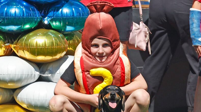 Briggs Sexton, wearing a hot dog costume, waits to release his wiener dog at the start line during the Wiener Dog Races Saturday, Sept. 21, 2024 during Mustard Fest. BILL LACKEY/STAFF