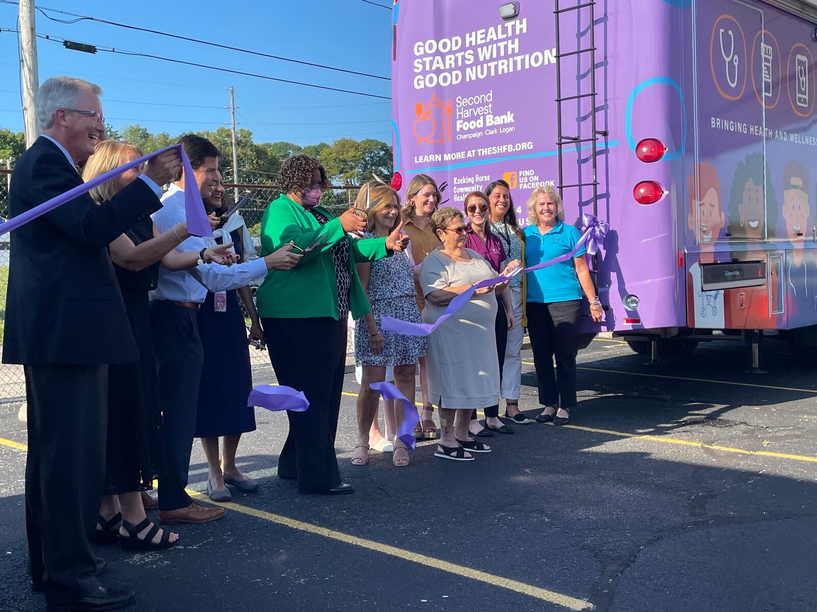 Rocking Horse, Second Harvest and Wilson Sheehan Foundation leaders cut the ribbon to kick off the addition of the health bus partnership.