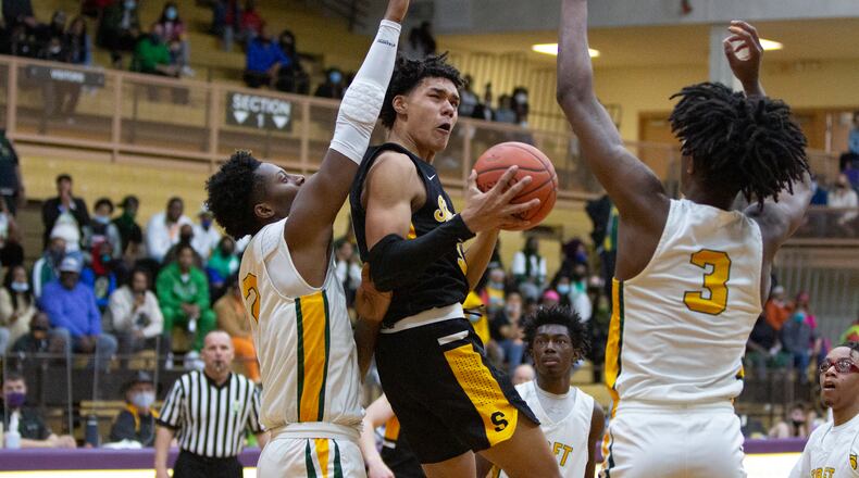 Shawnee's Zion Crowe tries to score against Cincinnati Taft's Rayvon Griffith (3) and AJ Lowe during the first half of Saturday's Division III regional final at Butler High School. Jeff Gilbert/CONTRIBUTED