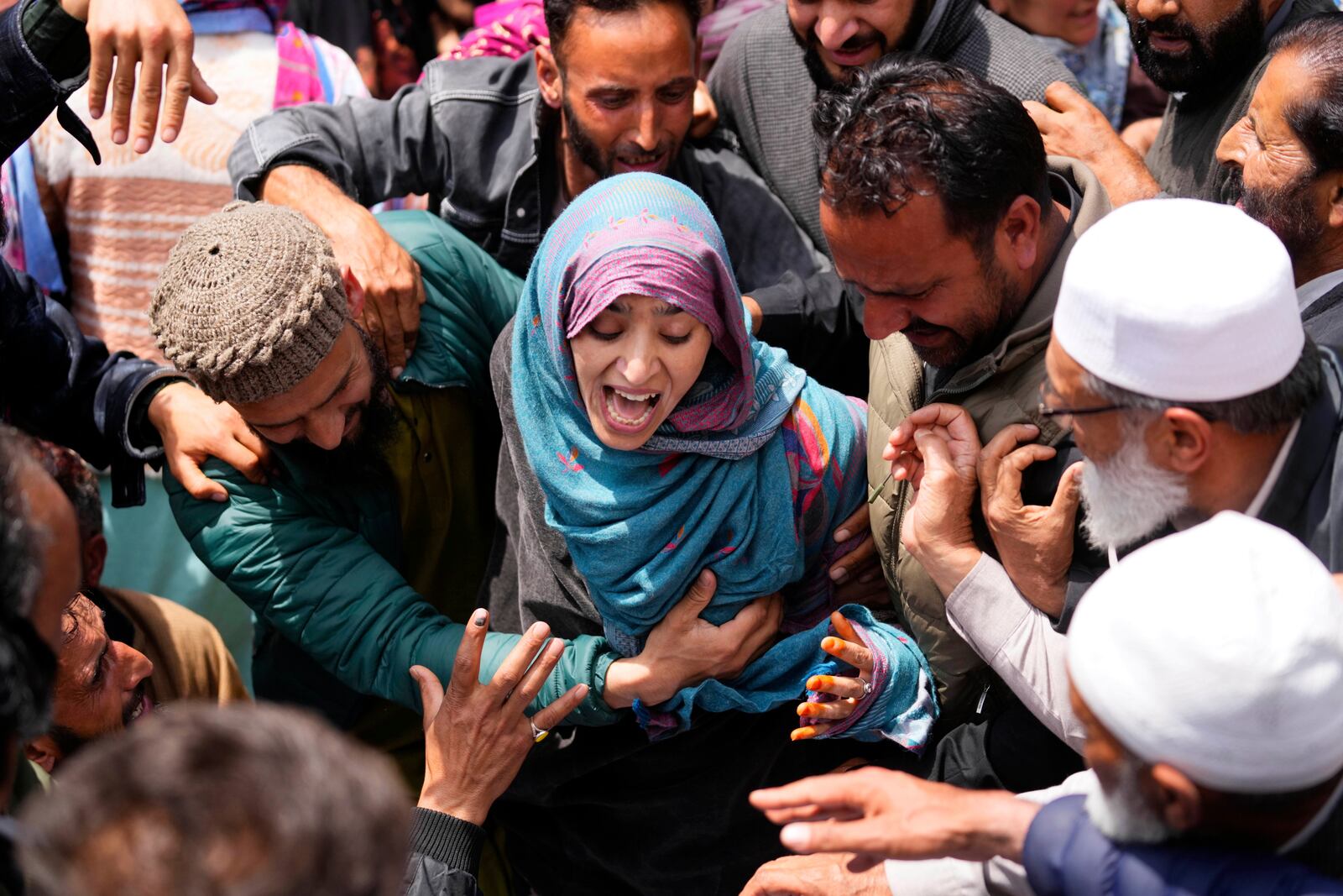 A relative wails during the funeral procession of Adil Hussain Shah, a daily-wage worker, who died when militants indiscriminately opened fire on a crowd of mainly tourists on Tuesday, at his village Hapatnar, about 20 km (13 miles) from Pahalgam where the incident took place, Indian controlled Kashmir, Wednesday, April 23, 2025. (AP Photo/Dar Yasin)