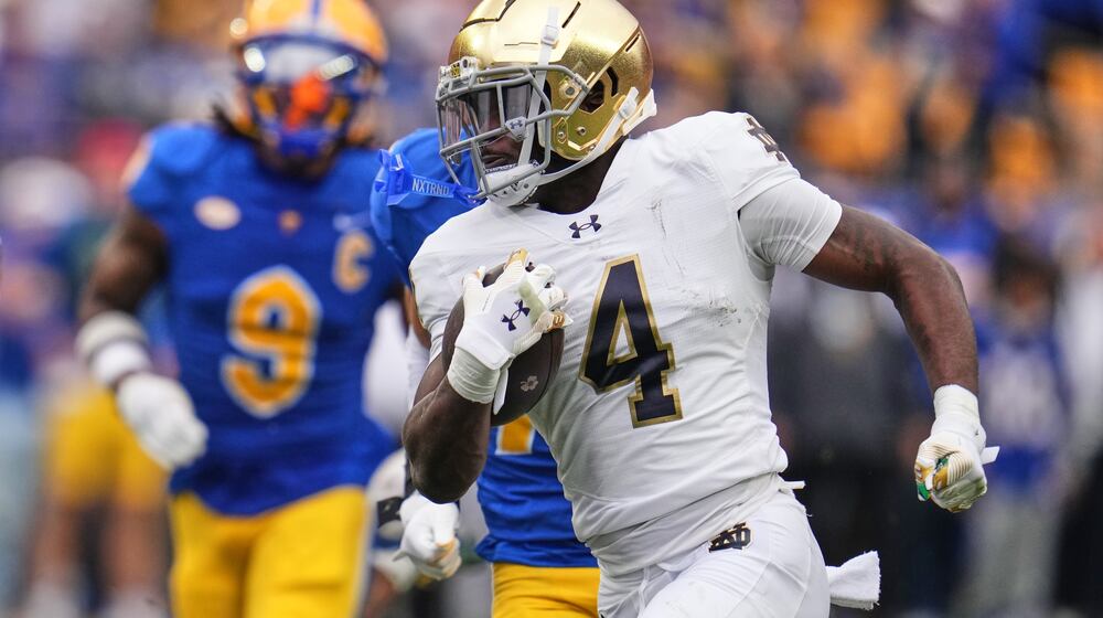 Notre Dame running back Jeremiyah Love (4) gets past Pittsburgh linebacker Kyle Louis (9) en route to a 65-yard touchdown run during the first half of an NCAA college football game in Pittsburgh, Saturday, Nov. 15, 2025. (AP Photo/Gene J. Puskar)