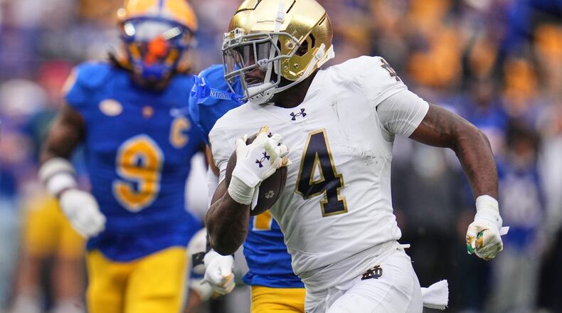Notre Dame running back Jeremiyah Love (4) gets past Pittsburgh linebacker Kyle Louis (9) en route to a 65-yard touchdown run during the first half of an NCAA college football game in Pittsburgh, Saturday, Nov. 15, 2025. (AP Photo/Gene J. Puskar)