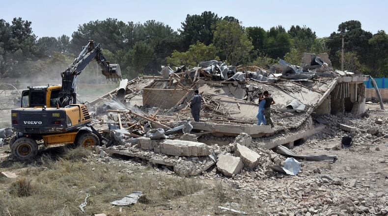 FILE - In this Tuesday, Aug. 25, 2020 file photo, Afghan Security personnel work at the site of a suicide truck bombing in northern Balkh province of Afghanistan. President Ashraf Ghani issued a decree late Saturday, Aug. 29, 2020, appointing a council for national reconciliation, which will have final say on whether the government will sign a peace deal with the Taliban after what are expected to be protracted and uncertain negotiations with the insurgents envisaged under a U.S.-Taliban peace agreement signed in February. Since signing the agreement, the Taliban have held to a promise not to attack U.S. and NATO troops, but have carried out regular attacks on Afghan security forces. (AP Photo, File)