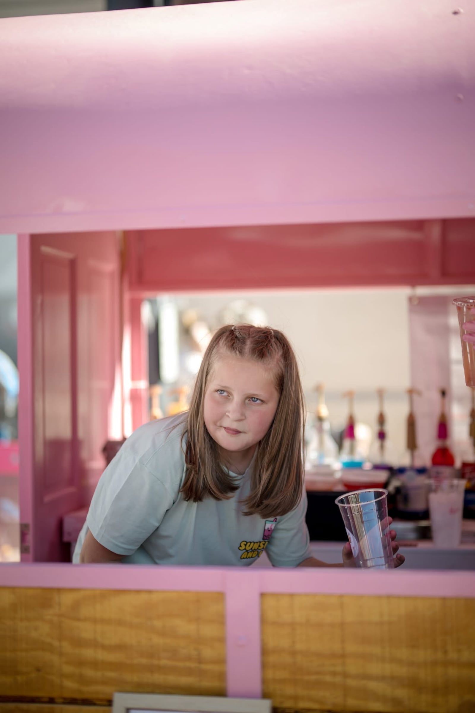 Urbana fourth grader Lydia Martinez works on mixing a drink order at her drink stand, Sunshine and Lyds, which is in a converted 4-H trailer. Lydia, 9, opened the lemonade stand earlier this summer, making creative drink mixes to sell at various events. CONTRIBUTED