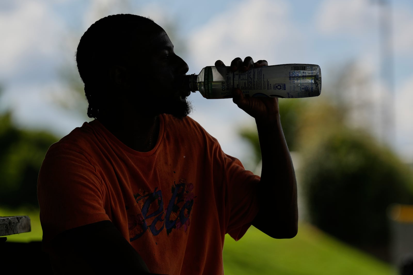 Marqui Scruggs takes a drink after playing basketball during a heat advisory Friday, July 25, 2025, in Murfreesboro, Tenn. (AP Photo/George Walker IV)