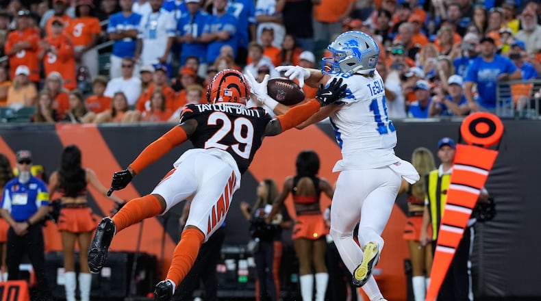 Detroit Lions wide receiver Isaac Teslaa (18) catches a 12-yard touchdown pass as Cincinnati Bengals cornerback Cam Taylor-Britt (29) defends during the second half of an NFL football game Sunday, Oct. 5, 2025, in Cincinnati. (AP Photo/Carolyn Kaster)