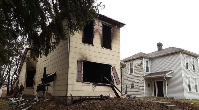 A fire in a two story house at 508 Rice Street over the weekend also damaged the house next door at 510 Rice Street. BILL LACKEY/STAFF