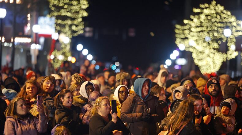 A crowd fills Fountain Avenue in downtown Springfield to watch Santa light the city's Christmas tree Friday, Nov. 24, 2023 during the Holiday in the City Grand Illumination. BILL LACKEY/STAFF