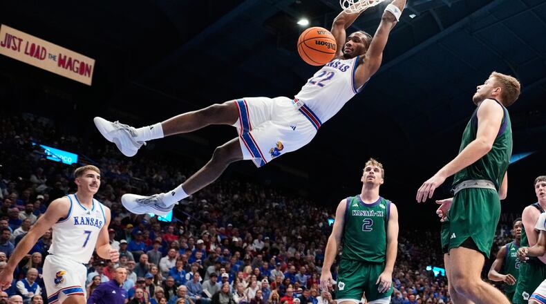 Kansas guard Darryn Peterson dunks the ball during the first half of an NCAA college basketball game against the Green Bay, Monday, Nov. 3, 2025, in Lawrence, Kan. (AP Photo/Charlie Riedel)