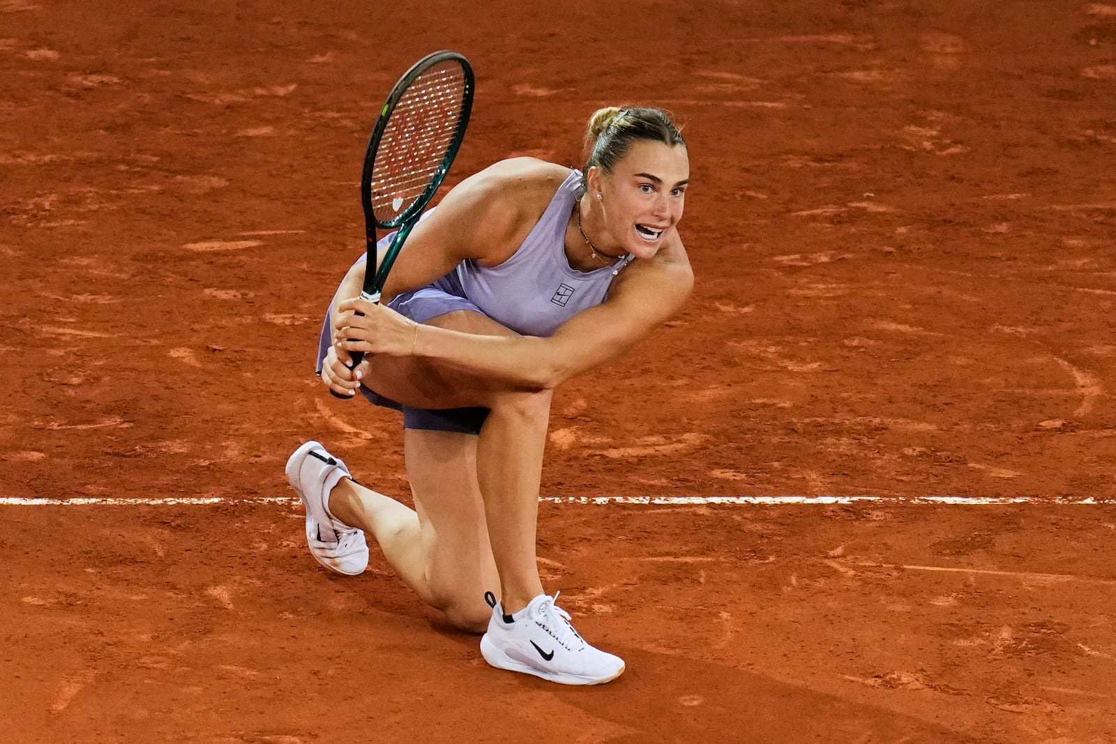 Aryna Sabalenka, of Belarus, returns the ball against Elina Svitolina, of Ukraine, during the Madrid Open tennis tournament in Madrid, Spain, Thursday, May 1, 2025. (AP Photo/Manu Fernandez)