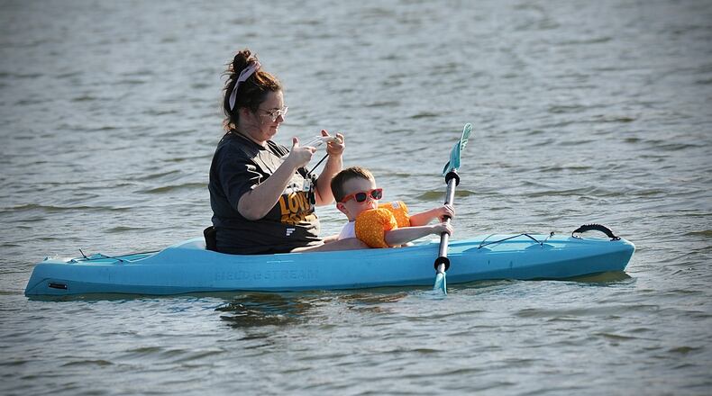 Victoria Stukenborg and her 4-year-old son Gannon take advantage of the warm weather on Wednesday, March 1, 2023, by kayaking on Eastwood Lake. MARSHALL GORBY \STAFF