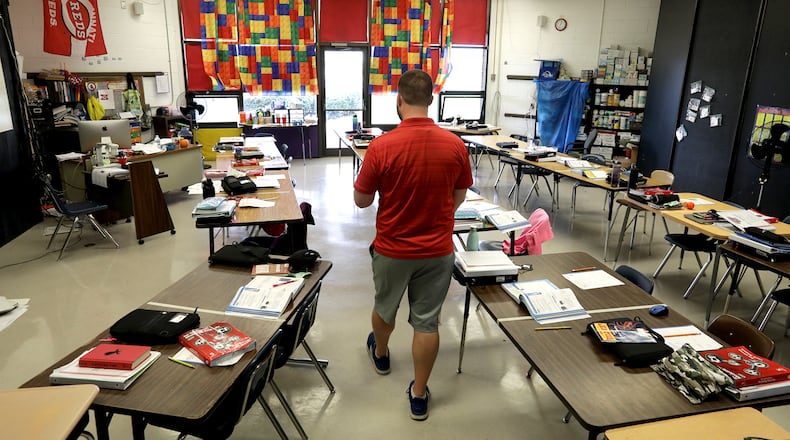 Clark and Champaign county school COVID-19 cases remain steady with 168 reported. Here, a teacher walks through his 5th grade classroom at South Vienna School while his students were at lunch. BILL LACKEY/STAFF