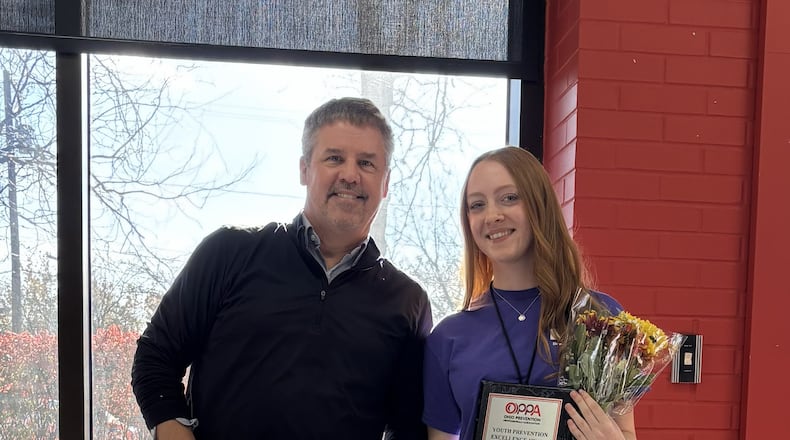 Springfield's Mary Cunningham received the Ohio Prevention Professionals Association’s 2025 Youth Community Champion Award at the Youth Prevention Showcase from executive director Jim Ryan in December. Cunningham is the president of the local Bringing Awareness to Students youth prevention group. CONTRIBUTED