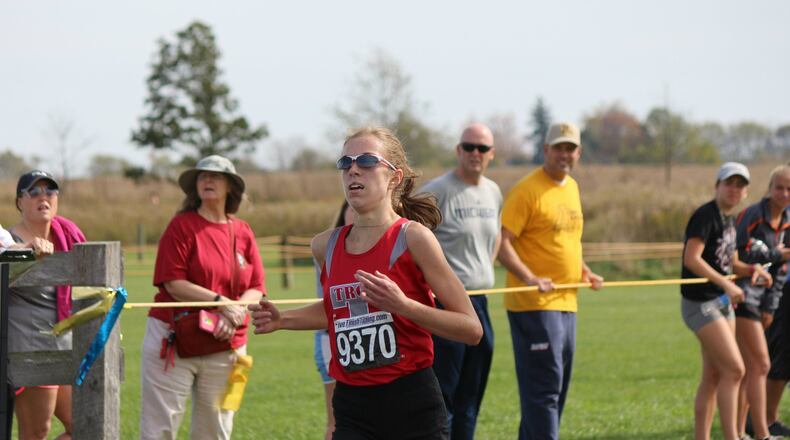 Morgan Gigandet of Troy won the girls Division I district cross-country meet in 17 minutes, 27.6 seconds. Springboro’s Lindsey Coffin finished second, seven seconds later. Springboro won the team championship. GREG BILLING / CONTRIBUTED