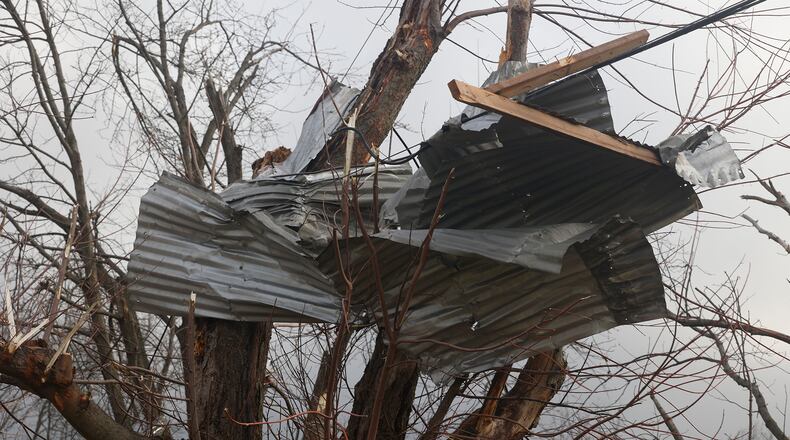 Metal debri wrapped around a tree along Ridge Road after Wednesday's storm. BILL LACKEY/STAFF