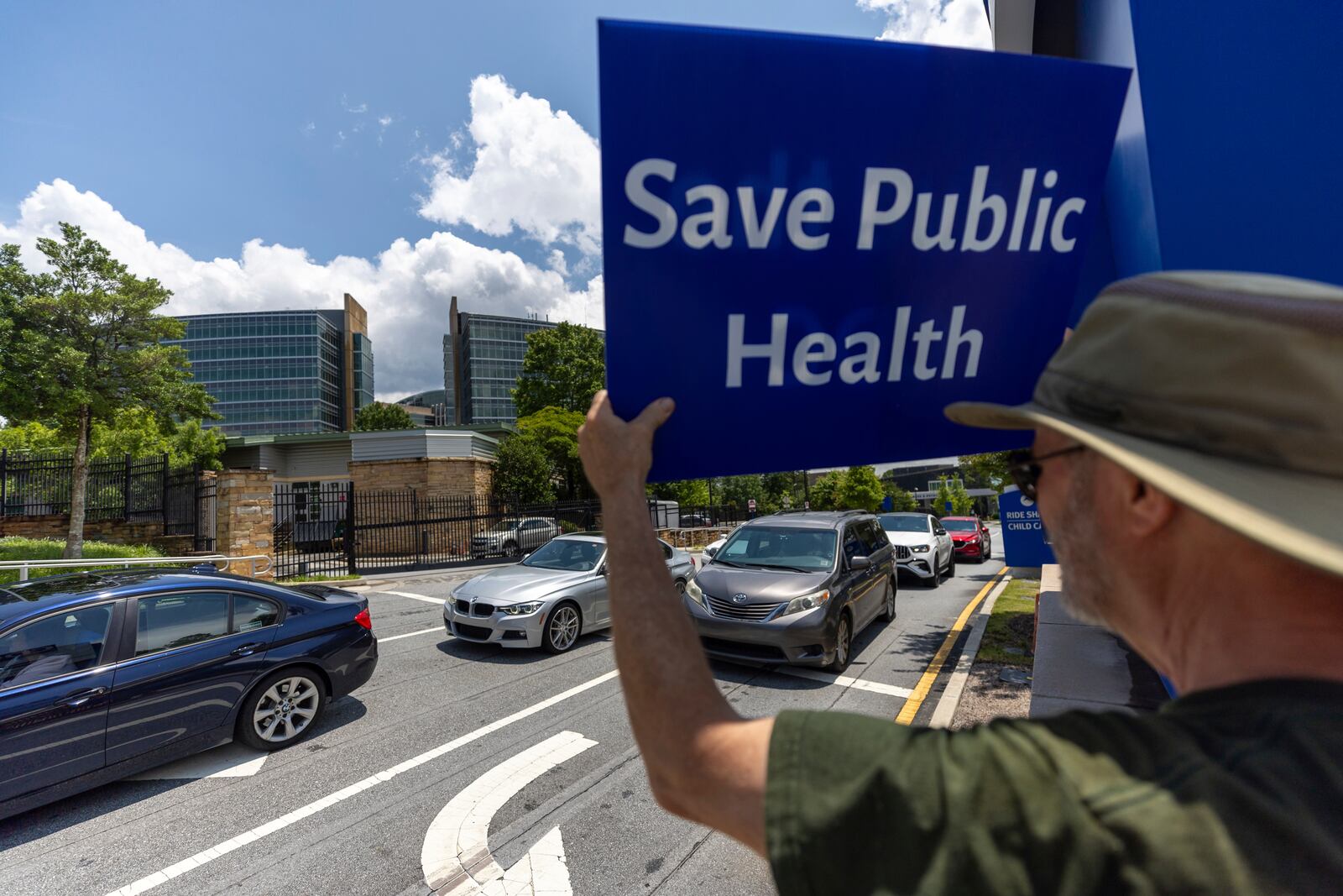 Michael Beach protests President Donald Trump's proposed cuts to health services outside the Centers for Disease Control and Prevention (CDC) headquarters in Atlanta on Tuesday, June 10, 2025. (Arvin Temkar/Atlanta Journal-Constitution via AP)