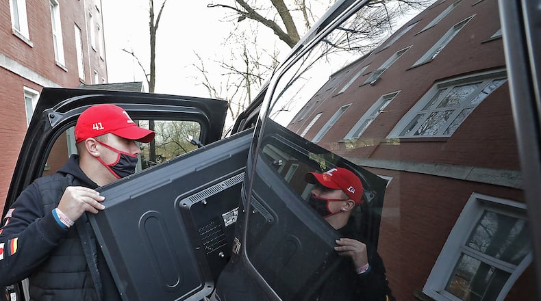 John Banks, a freshman at Wittenberg University, unloads a television from his family's car as he moves back into Myers Hall on campus in January. BILL LACKEY/STAFF