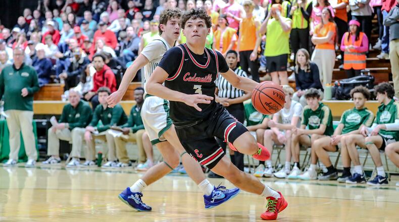 Cedarville High School junior Nate Van Loo drives past Catholic Central junior Berkeley Little during their game on Friday, Feb. 14 at Jason Collier Gymnasium in Springfield. The Indians beat the Irish 50-44 to earn a share of the Ohio Heritage Conference South Division title. MICHAEL COOPER/CONTRIBUTED