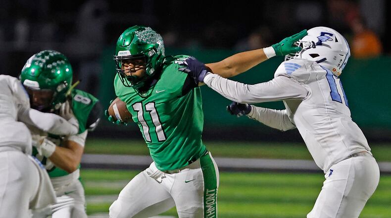 Northmont's Calilin Grant tries to avoid a tackle by Fairborn's Cayden Osbourne Friday, Oct. 27, 2023. BIILL LACKEY/STAFF