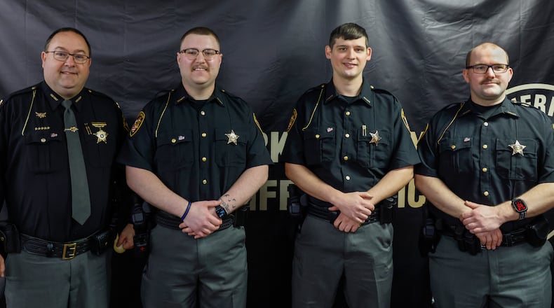 Left to right, Sheriff Chris Clark stands by Deputies Austin Eubanks, Joshua Hadley and Thomas Schaefer, after swearing them into the Clark County Sheriff’s Office on Monday, March 16, 2026, in Springfield. JOSEPH COOKE/STAFF