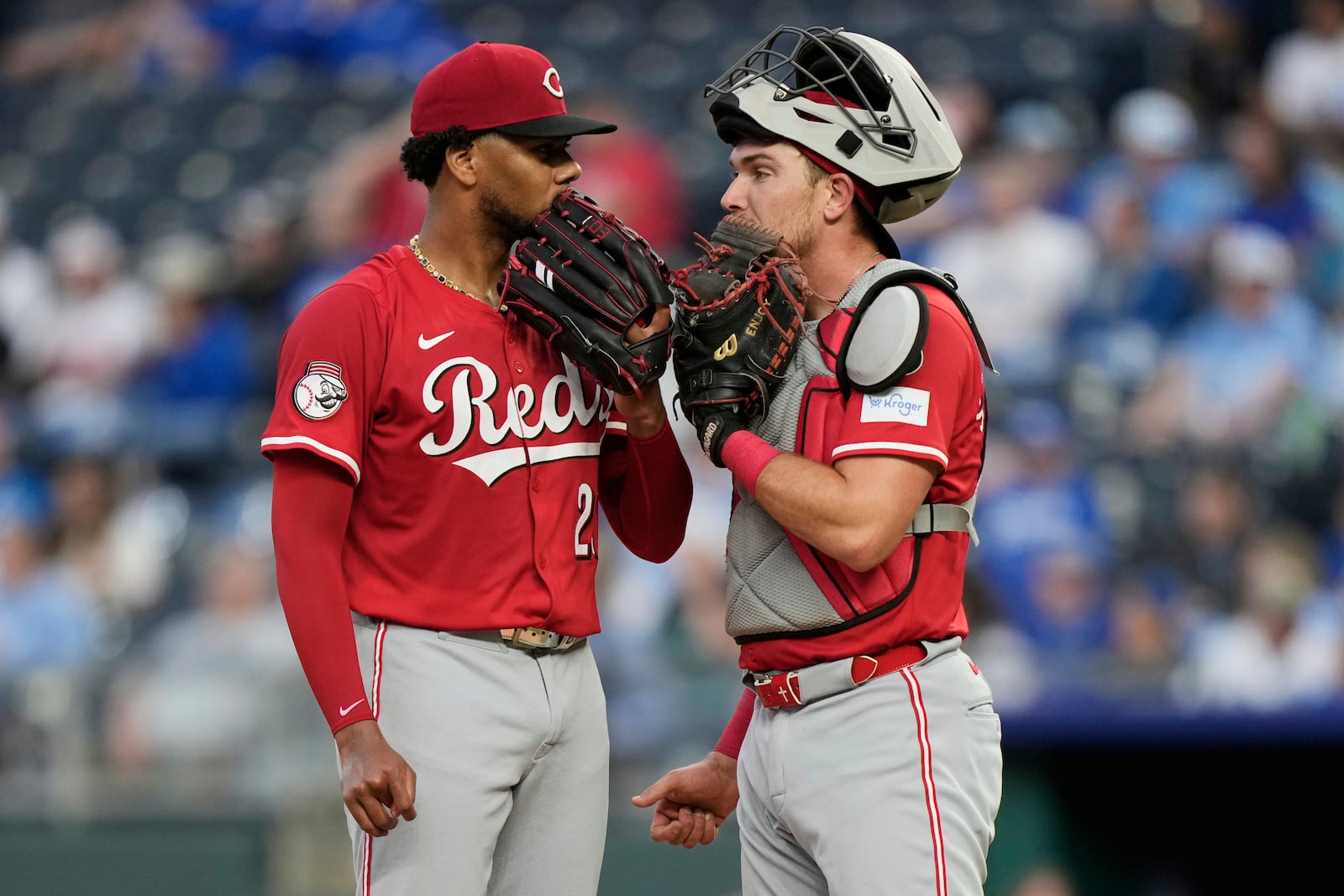 Cincinnati Reds starting pitcher Hunter Greene and catcher Tyler Stephenson meet on the mound during the fourth inning of a baseball game against the Kansas City Royals, Wednesday, May 28, 2025, in Kansas City, Mo. (AP Photo/Charlie Riedel)