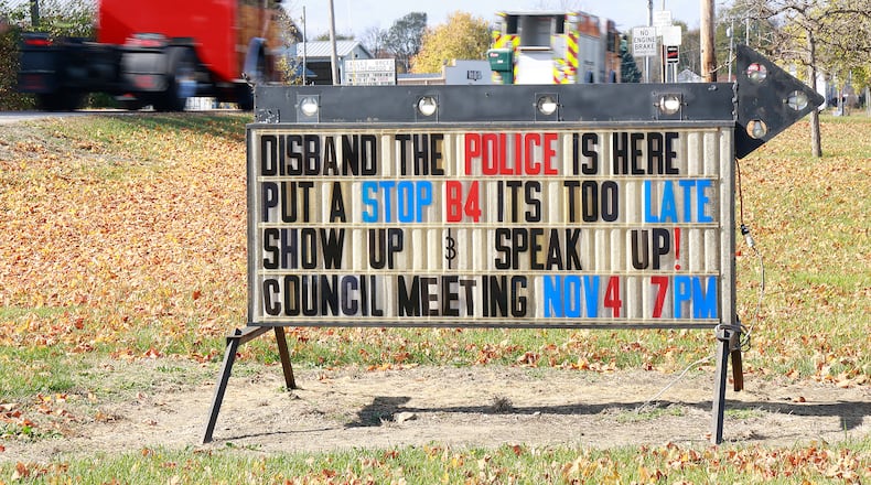 A sign on Ohio Route 36 on the edge of St. Paris about disbanding the St. Paris Police Department. BILL LACKEY/STAFF