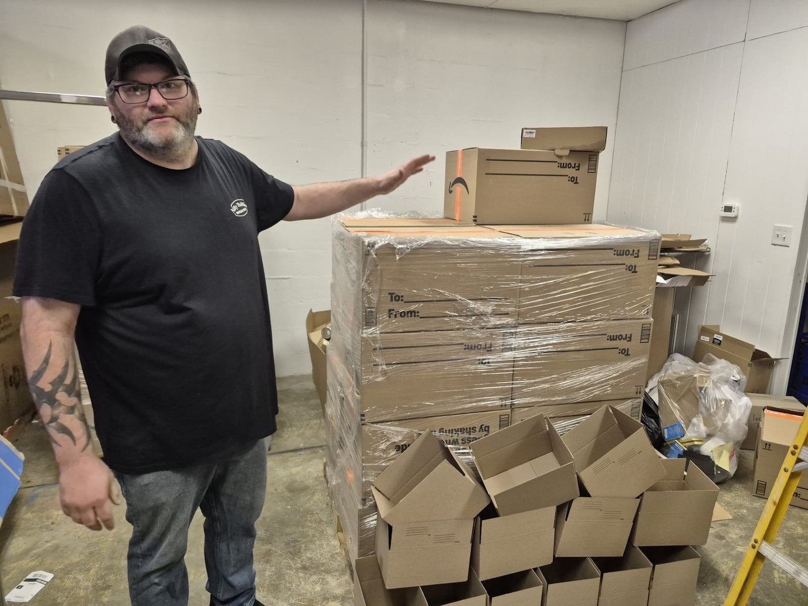 Cody Penwell, owner of Nifty Thrifties Bargain Bins in Enon, sells unopened "mystery" boxes for $60. They can contain anything from underwear and socks to PlayStations. MICHAEL KURTZ / STAFF