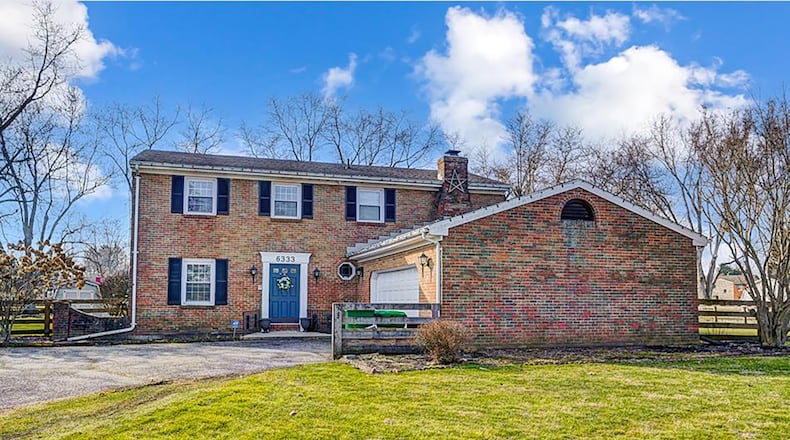 The front of the all-brick home has a two-car attached garage and asphalt driveway. CONTRIBUTED PHOTOS