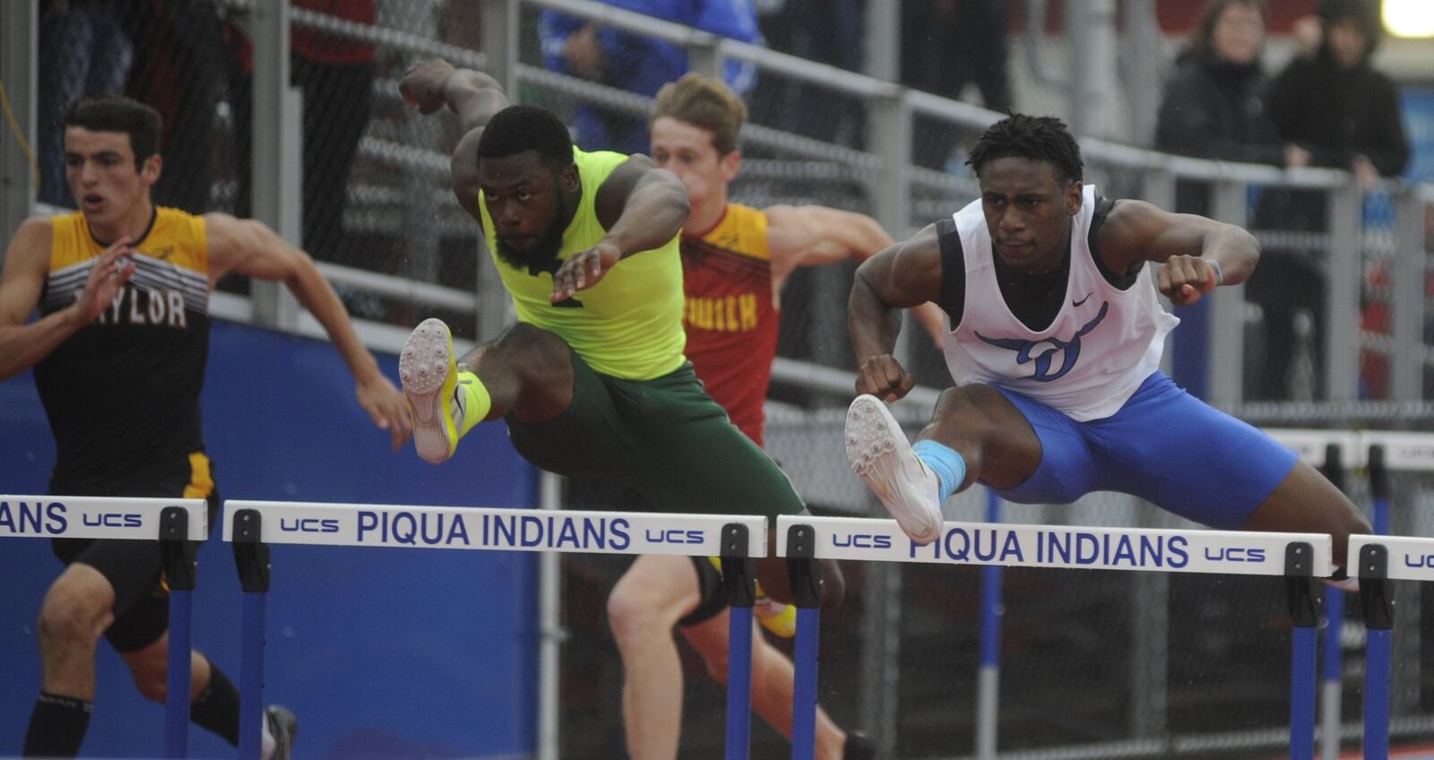 Dunbar’s Jalani Allen (right) takes a slight lead in the 110 high hurdles during the D-II regional track and field meet at Piqua’s Alexander Stadium on Thursday, May 25, 2017. MARC PENDLETON / STAFF