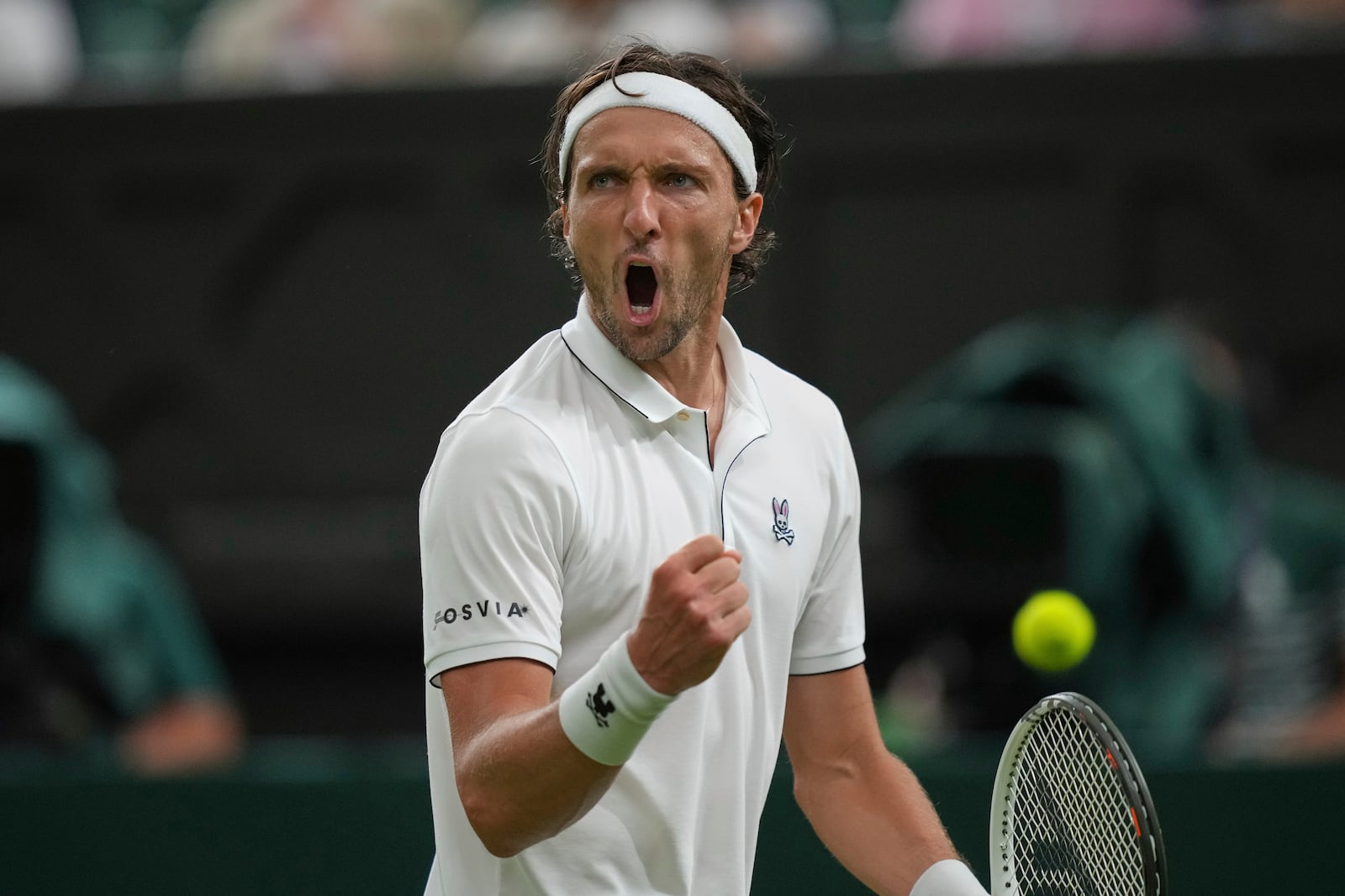 Arthur Rinderknech of France reacts after winning a point against Alexander Zverev of Germany in their first round men's singles match at the Wimbledon Tennis Championships in London, Monday, June 30, 2025. (AP Photo/Alastair Grant)