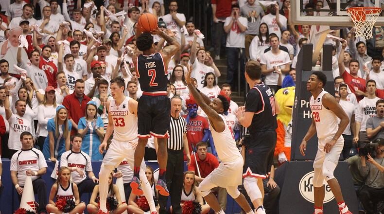 Richmond’s Khwan Fore shoots a 3-pointer against Dayton’s John Crosby on Jan. 19, 2017, at UD Arena. David Jablonski/Staff