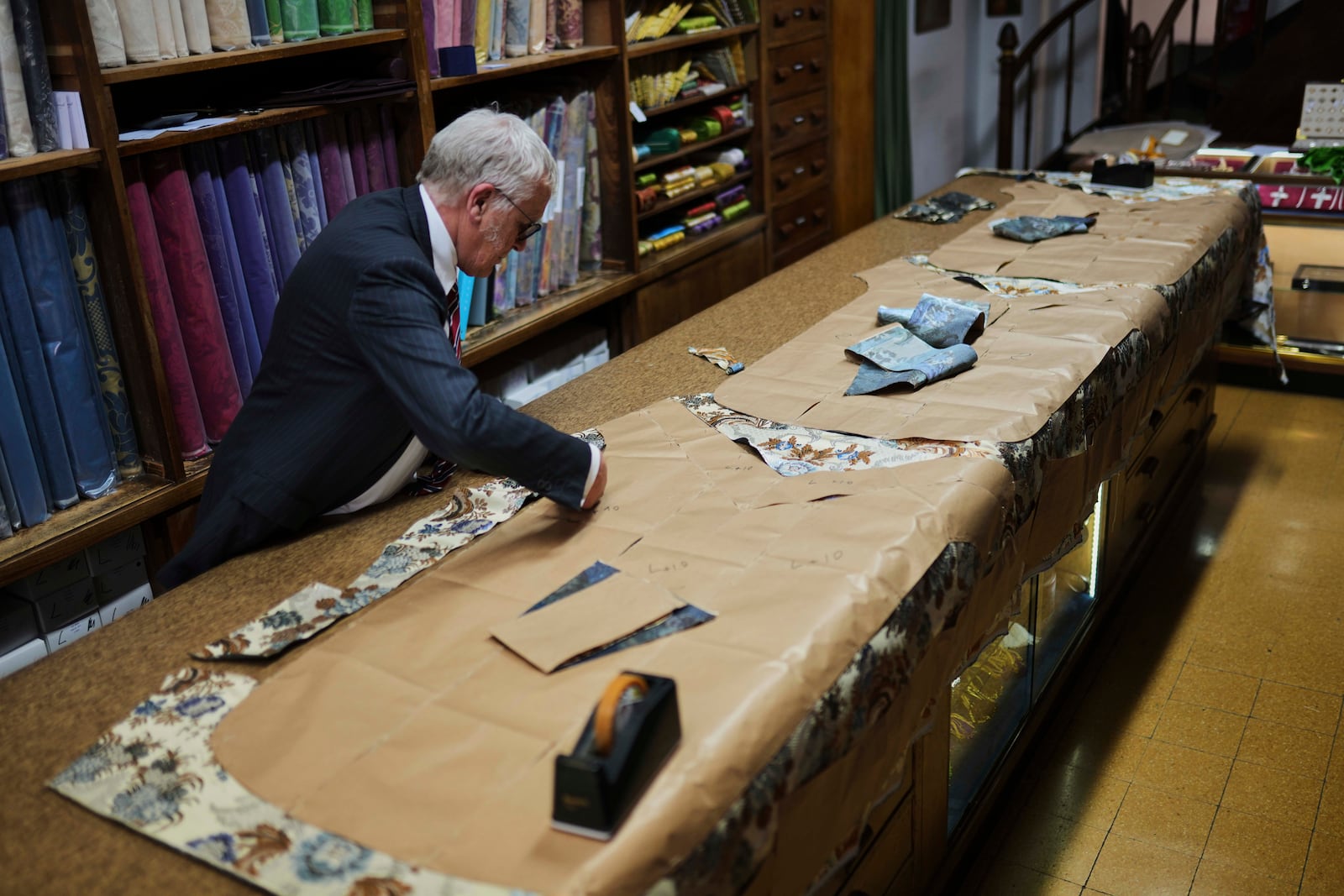 A tailor works at the Gammarelli ecclesiastic clothes tailor shop in Rome, Wednesday, April 30, 2025. (AP Photo/Francisco Seco)