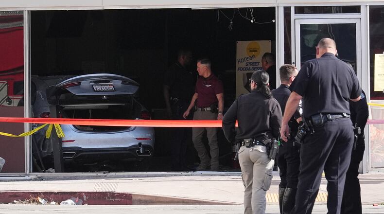 A car is seen inside of a 99 Ranch Market at the scene of a fatal crash Thursday, Feb. 5, 2026, in the Westwood neighborhood of Los Angeles.(AP Photo/Damian Dovarganes)