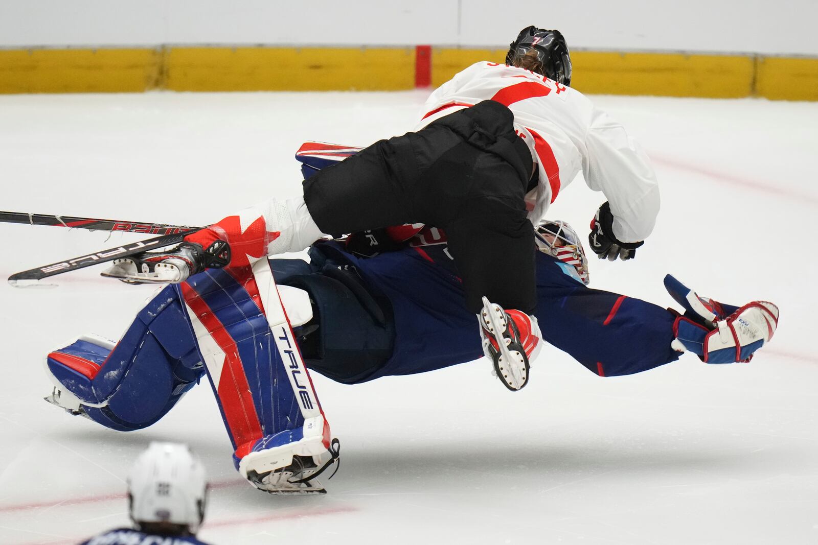 Canada's Laura Stacey collides with United States' goalkeeper Aerin Frankel during the gold medal match between Canada and United States at the Women's Ice Hockey Championships in Ceske Budejovice, Czech Republic, Sunday, April 20, 2025. (AP Photo/Petr David Josek)