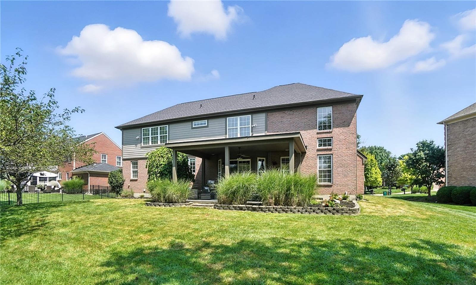 The back of the home has a covered patio with ceiling fan and there is an invisible fence and landscaping. CONTRIBUTED