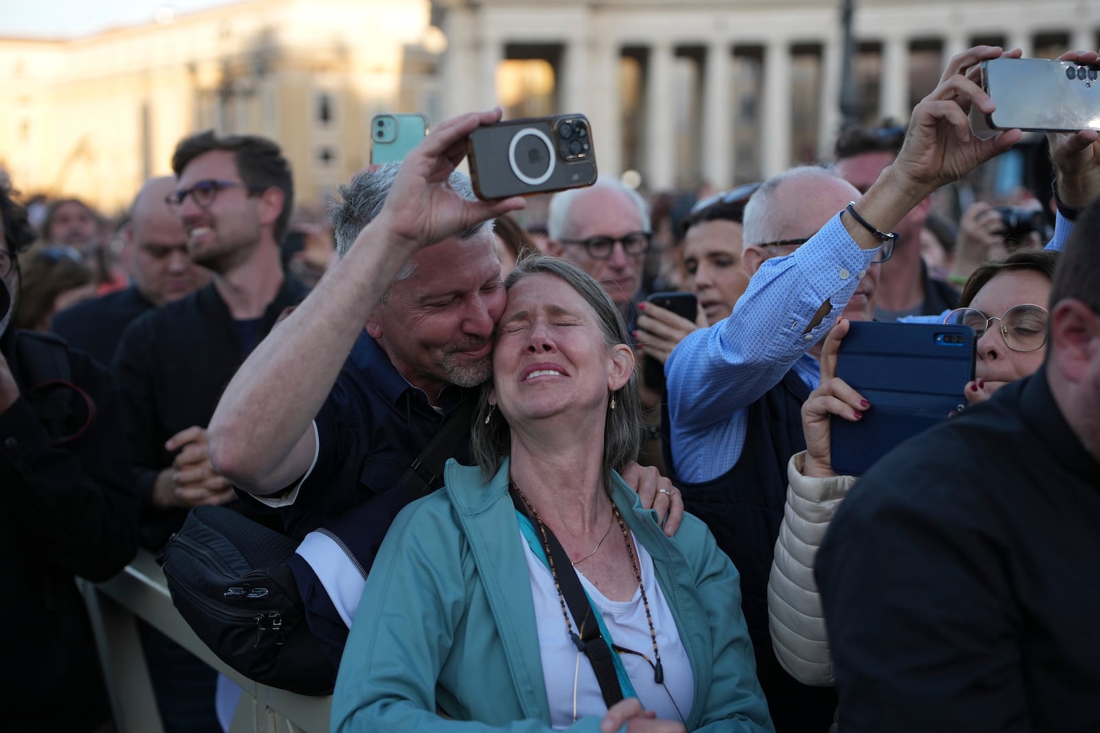 People react as the newly elected Pope Leo XIV appears on the balcony of St. Peter's Basilica at the Vatican, Thursday, May 8, 2025. (AP Photo/Emilio Morenatti)