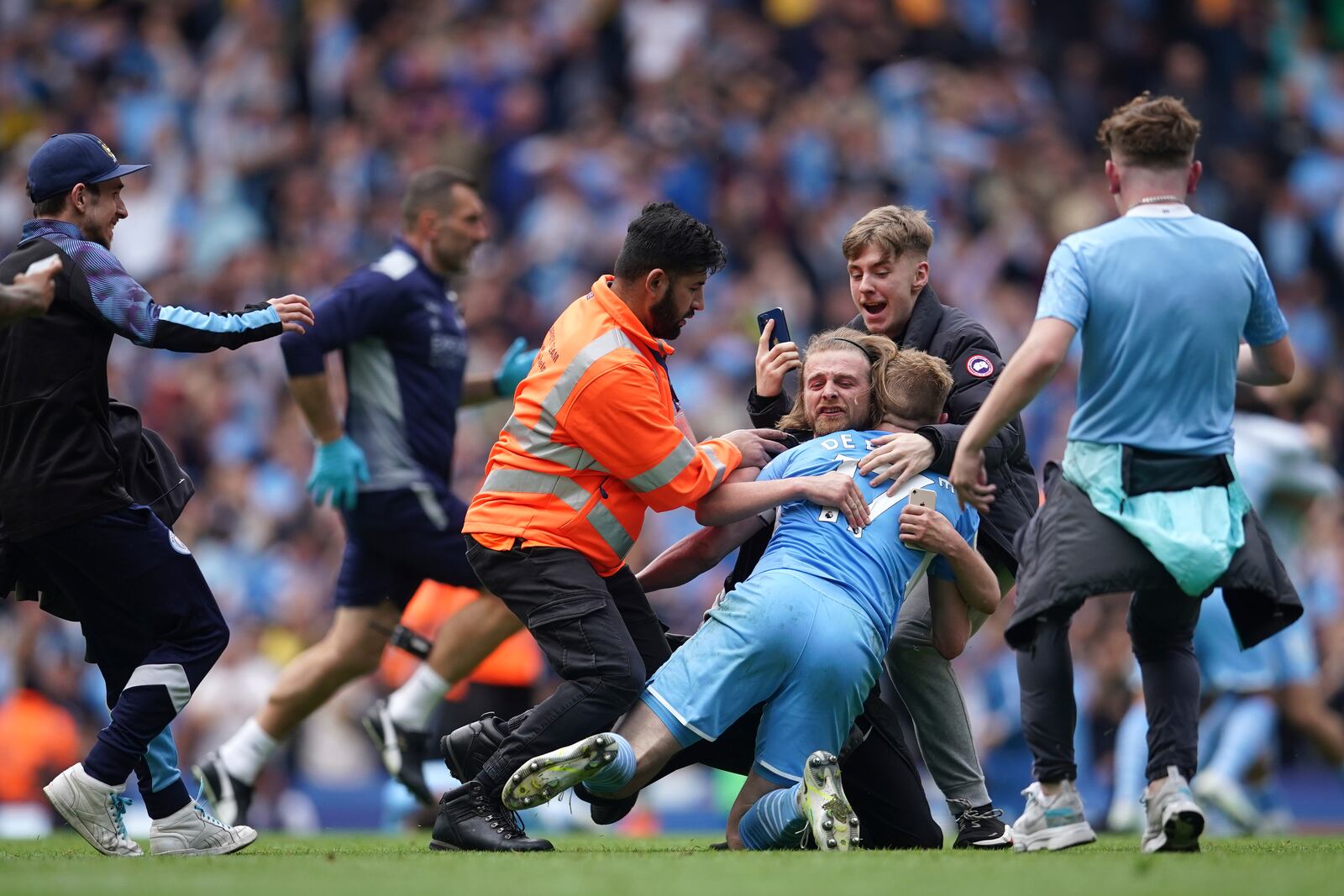 FILE - Manchester City's Kevin De Bruyne celebrates with fans after winning the English Premier League soccer match between Manchester City and Aston Villa at the Etihad Stadium in Manchester, England, Sunday, May 22, 2022.(AP Photo/Dave Thompson, file)